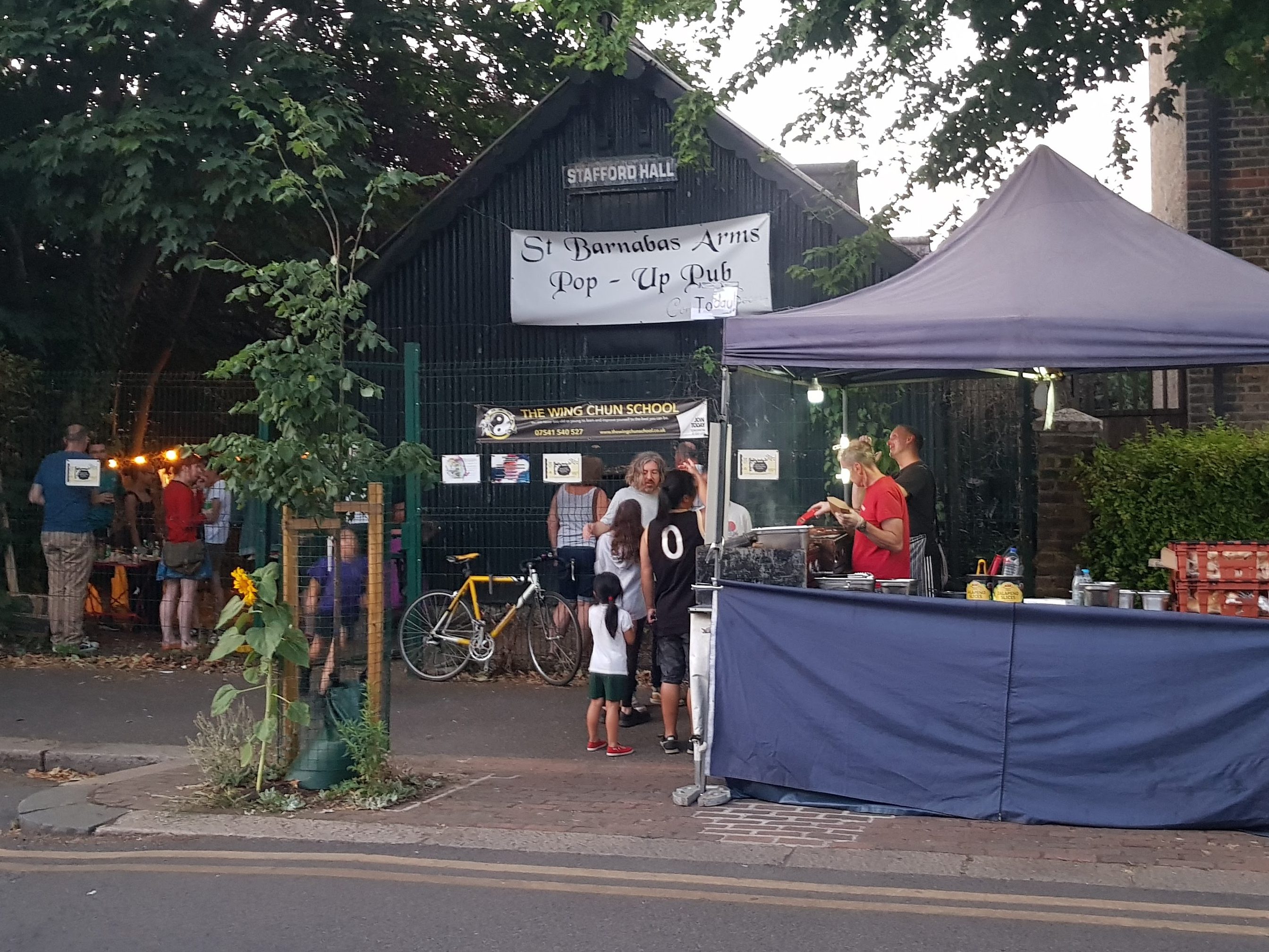 Exterior of Stafford Hall while being used as pop-up pub.  Hot dog stall on pavement